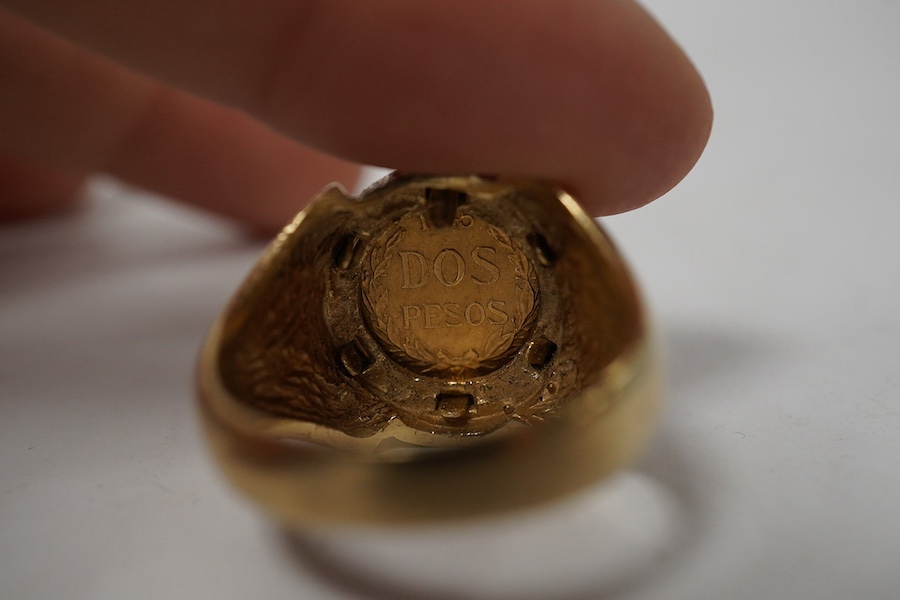 A 9ct gold ring set with a gold Mexican Two Peso coin, size R1/2, British hallmarks, gross weight approximately 9 grams. Condition - good, some scratches